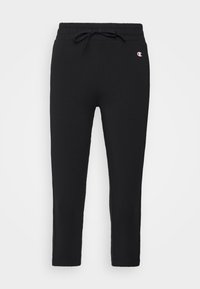 Svarta slim-fit sweatpants med elastisk midja och dragsko, med liten Champion-logotyp på övre vänstra sidan.