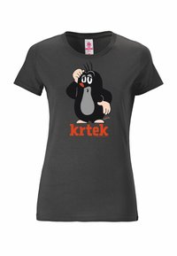Black cotton t-shirt featuring a cartoon character of a mole, with white chest and eyes, and red accents. "krtek" text is in bold orange.