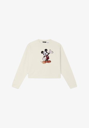 Sweatshirt cropped de couleur crème avec un design brodé de Mickey Mouse en rouge et noir. Manches longues avec poignets côtes.
