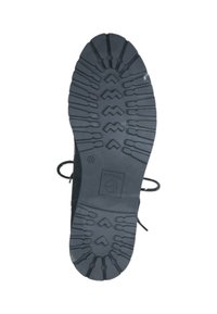 Suela de goma negra con patrones de relieve profundos y angulares para una mejor tracción. Textura lisa con un logotipo y detalles de tamaño grabados en el lateral.
