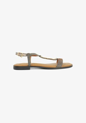 Plat sandaal met bandjes, een metalen geweven bovenwerk, een bruine leren binnenzool en een zwarte rubberen zool. Voorzien van een verstelbare enkelriem.