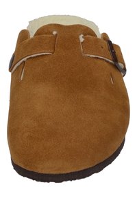 Brown suede slipper with a soft textile lining, featuring a buckle strap and a rounded toe, flat sole, and no visible patterns.
