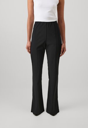 Black flared trousers with a high elastic waistband, smooth texture, and tailored fit, presented on a light gray background.
