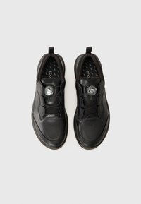 Black athletic shoes with a smooth leather upper, mesh accents, round toe, and lacing system featuring a circular dial for adjustable fit.
