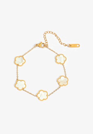 Gold chain bracelet with five white mother-of-pearl flower charms and a lobster clasp, including an adjustable extension chain.