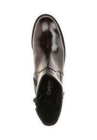 Botte cheville en cuir brun avec une finition brillante, dotée d'un côté élastique, d'un bout arrondi et d'une fermeture éclair pour un enfilage plus facile.