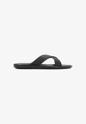 Schwarze Flip-Flops mit strukturiertem Obermaterial mit Perforationen, kontrastierenden roten Ziernähten und einer glatten, flachen Sohle.