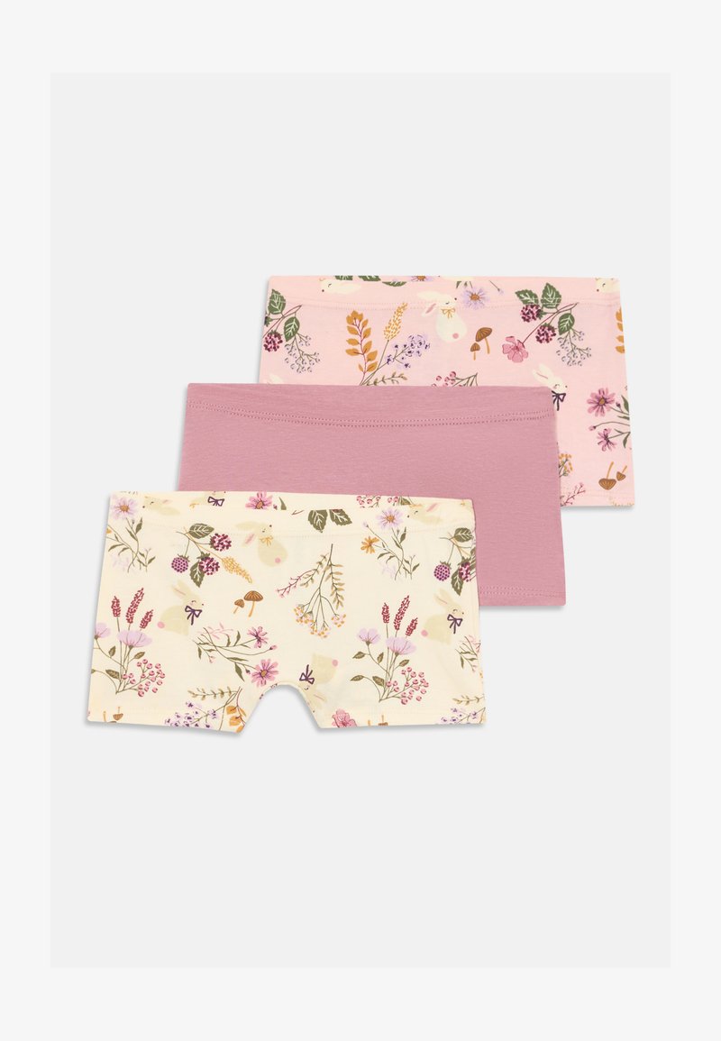 Tre pantaloni corti da ragazza in rosa, malva e crema con stampe floreali e di coniglietti, impilati e disposti su uno sfondo bianco.