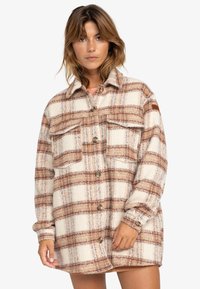 Beige wollen plaid shirt-jack met grote bruine en blauwe vakken, knoopsluiting aan de voorkant, twee borstzakken en een ronde kraag.