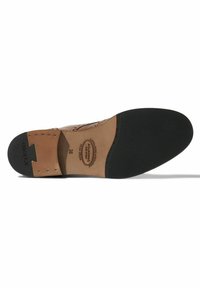 Sole di scarpa in pelle marrone con superficie di trazione in gomma nera, caratterizzata da un motivo testurizzato e dettagli del logo in rilievo sulla soletta.