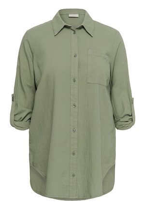 Vaaleanvihreä pitkähihainen nappipaita, jossa on etutasku rinnassa ja käärityt hihat, jotka on kiinnitetty napillisisilla hihansuihin.