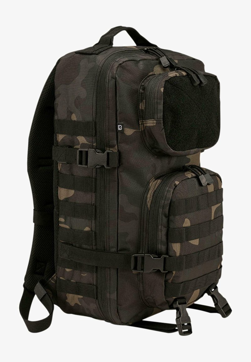 Ruksak s kamuflažnim vzorcem, izdelan iz trpežne tkanine. Ima več predelkov, nastavljive trakove, ročaj na vrhu in stransko pletenico za pritrditev.