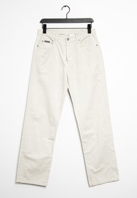 Ljust beige vida byxor i bomull, med två framfickor, metallknapp och en textil etikett på linningen.