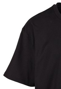 Black cotton t-shirt with short sleeves, round neckline, and smooth texture. Features a relaxed fit with a clean, simple design.