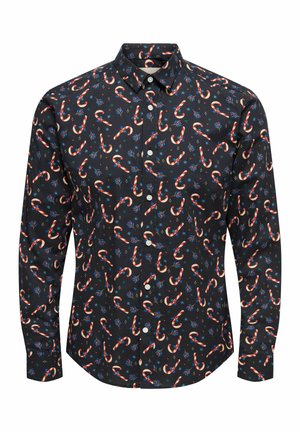 Svart långärmad skjorta med knappar, mönstrad med röda och vita polkagrisar samt blå blommor, klassisk krage och vita knappar fram.