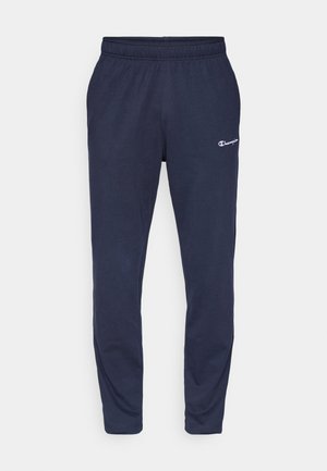 Pantalons de jogging navy en tissu doux, avec une taille élastique et un petit logo blanc sur la cuisse gauche. Conception de jambe fuselée.