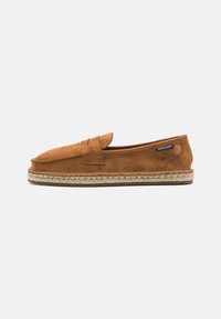 Brown suede slip-on shoe with a rounded toe, featuring a woven jute sole and a small accent strap across the front.