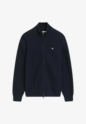 Marineblaue Zip-Jacke mit einem strukturierten Muster, Rippkragen und -bündchen sowie einem kleinen Logo auf der Brust. Hergestellt aus weichem Strickmaterial.