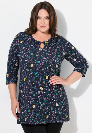 Floral patterned tunic featuring a dark navy background, round neckline with a keyhole, and three-quarter sleeves. Fabric appears soft and lightweight.