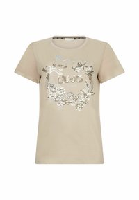 T-shirt beige en coton à manches courtes, orné d'un design floral argenté et du logo "LIU JO" au centre dans une police décorative.