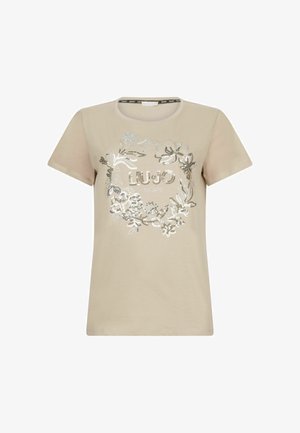 Beidzīs krāsas krekls no kokvilnas ar īsām piedurknēm, ar sudraba ziedu rakstu un logo "LIU JO" centrā dekoratīvā fontā.