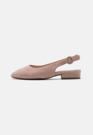 Blush pink slingback shoe with a rounded toe, made of suede-like material. Features a flat heel and a circular adjustable strap accent.