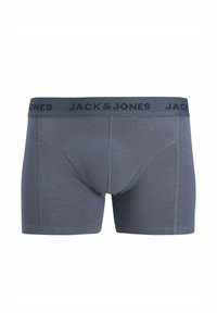 Bóxer gris de tela suave con una cinturilla elástica negra que muestra "JACK & JONES" en negrita. Presenta un ajuste ceñido y costuras planas.