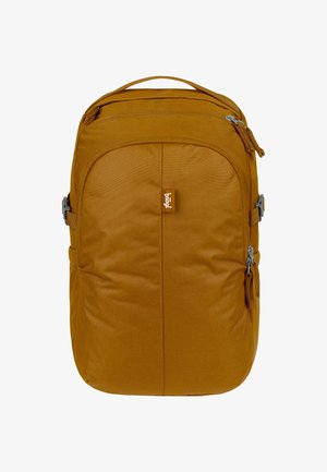 Brown fabric backpack with a padded front, zippered pockets, and adjustable side straps. Features a discrete logo tag on the front.