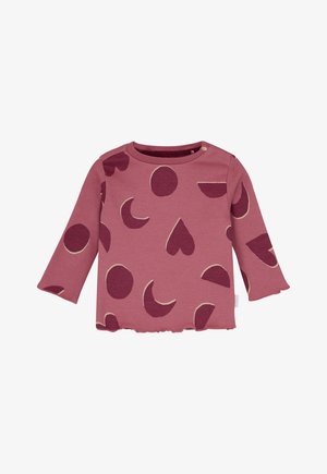 Long-sleeve baby shirt in dusty rose with dark pink geometric shapes and scalloped edges, featuring shoulder button closure.