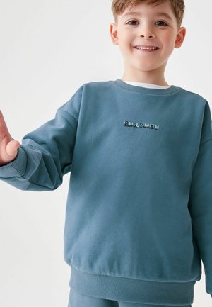 Modrá mikina s dlhými rukávmi, okrúhlym výstrihom, a rebrovanými manžetami a spodným lemom. Na prednej strane sa nachádza vyšívané logo "Paul Smith". Mäkká textúra.