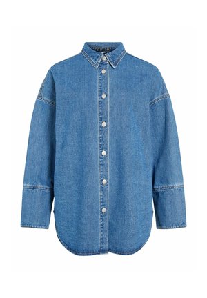 Denimskjorte i lyseblå, med knappestolpe foran, spiss krage, lange ermer og avrundet kant. Synlige sømmer og sølvfargede knapper.