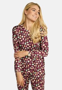 Komplet majice z dolgimi rokavi in hlač v globoki bordo rdeči barvi, z prazničnim vzorcem okraskov, pentelj in dreves v več pastelnih barvah.