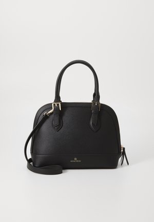 Sac à main en cuir noir avec boucles dorées, deux poignées, une bandoulière amovible et logo Anna Field au centre à l'avant.