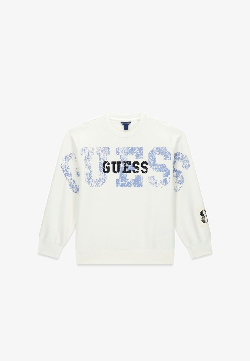 Sweatshirt blanc à manches longues et col rond avec un grand texte "GUESS" bleu usé sur le devant et un plus petit texte noir "GUESS" superposé au centre.