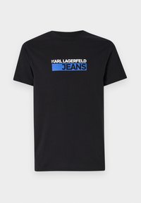 Juodas medvilninis marškinėlis su baltu ir mėlynu grafiniu logotipo tekstu "KARL LAGERFELD JEANS" priekyje. Trumpomis rankovėmis, apvaliu kaklu.