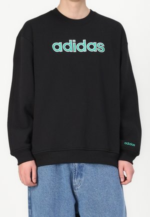 Černá mikina vyrobená z bavlněné směsi, s velkým tyrkysovým logem "adidas" na přední straně a menším logem na rukávu.