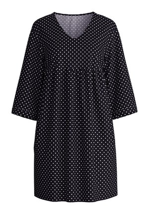Zwarte jurk met witte stippen, V-hals en driekwartmouwen. Heeft een gebundelde taille voor een losse pasvorm.