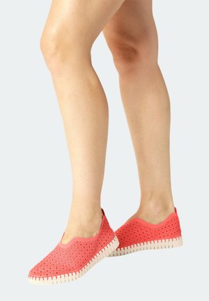 Coral slip-on shoes featuring a textured upper with cut-out patterns, white rubber soles, and a lightweight design for comfort.