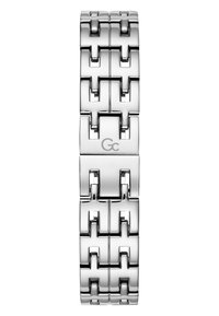 Armbands i rostfritt stål med sammankopplade geometriska länkar, silverfärgad finish, cirkulär logotypdetalj som har en mjuk yta och polerad yta.