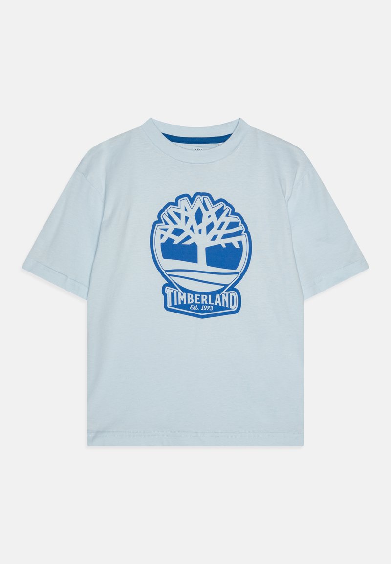 Svijetloplava kratkotrajna majica od pamuka. Ima veliki plavi logotip drveta i grafiku "TIMBERLAND Est. 1973" na prednjoj strani.