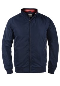 Navy blue bomber jacket with a zip front, ribbed cuffs, and collar. Features side pockets and a striped interior lining. Smooth texture.