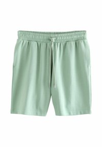 Lys grønne shorts med snøre lavet af blødt stof. Har en elastisk talje og to sidelommer. Glat tekstur, afslappet design.