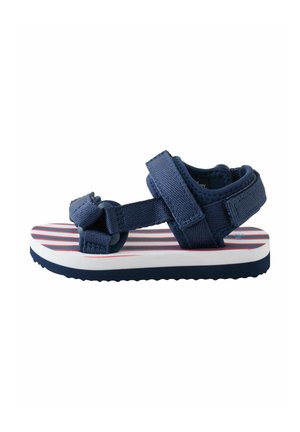 Navy blue toddler sandal with adjustable straps and cushioned sole featuring red and white stripes, shown in side view on white background.