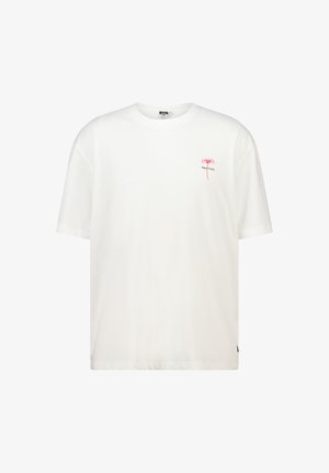 T-shirt en coton blanc avec un col rond et des manches courtes. Présente un petit motif rose d'un arbre et le texte "New York" en noir.