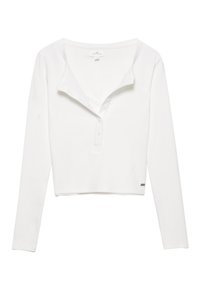 Valkoinen pitkähihaisen henley-paita, jossa on ribbikuviointi, nappisulku ja pyöreä pääntie. Ominaisuuksiin kuuluu lyhennetty malli ja hillitty brändäys.