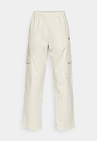 Béžové cargo kalhoty s volným střihem. Mají elastický pas a boční kapsy. Vyrobeny z lehkého materiálu s hladkým povrchem.