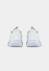 White athletic shoes with a textured mesh upper, pull tab, and a lightweight rubber sole featuring a patterned grip. Logo on the side.