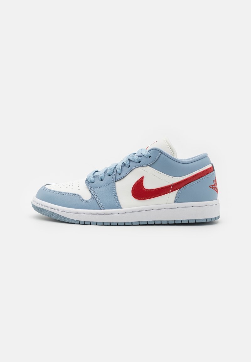 Low-top sneaker featuring a white leather base with light blue overlays and a red swoosh. Rubber sole with textured grip.