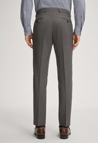 Gray tailored trousers with a smooth texture, featuring double pleats, back pockets with buttons, and worn with brown dress shoes.
