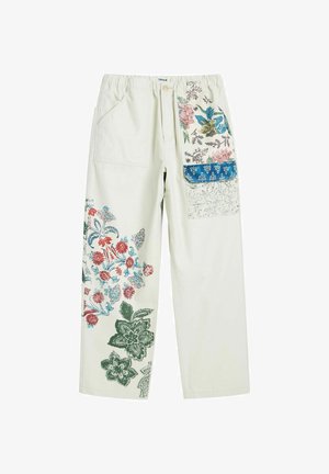Krémové nohavice s farebnými kvetinovými potlačami na ľavej nohe a pravom vrecku s klopou, s elastickým pásom a zapínaním na gombík.